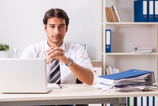 Young handsome businessman working in office