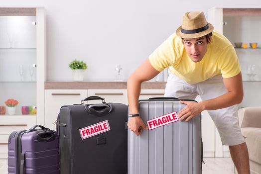 Man going on vacation with fragile suitcases