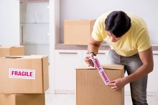 Man moving house and relocating with fragile items