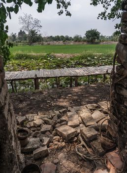 Bamboo bridge in the white lotus field Looking through the old red brick walls. No focus, specifically.
