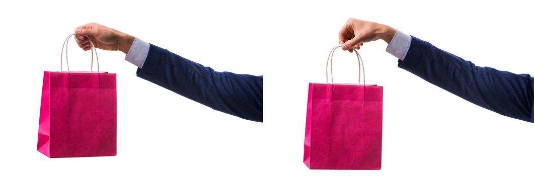 Hand holding shopping bags with christmas shopping on white back