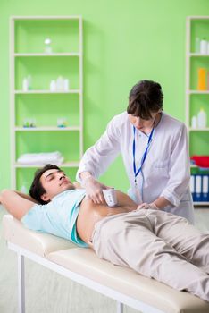 Young man visiting radiologyst for ultrasound procedure 