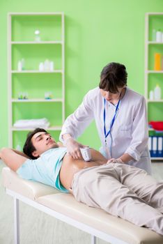 Young man visiting radiologyst for ultrasound procedure 