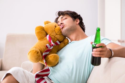 Young drunk handsome man after party at home 