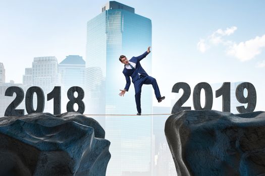 Businessman balancing between 2018 and 2018