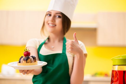 Young cook cooking cakes in the kitchen