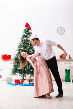 Young pair celebrating christmas at home