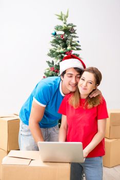 Young family celebrating christmas in new home