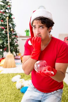 Man cleaning his apartment after christmas party