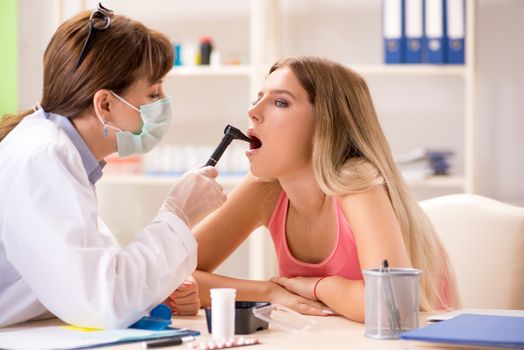 Young beautiful woman visiting female dentist 