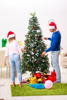 Young family celebrating christmas at home