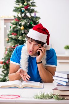 Young student with book at Christmas eve 