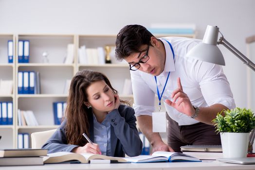 Teacher explaining to student at lecture