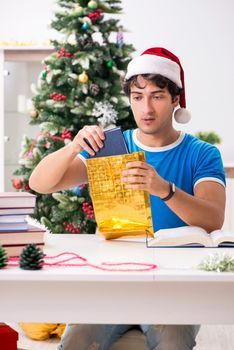 Young student with book at Christmas eve 