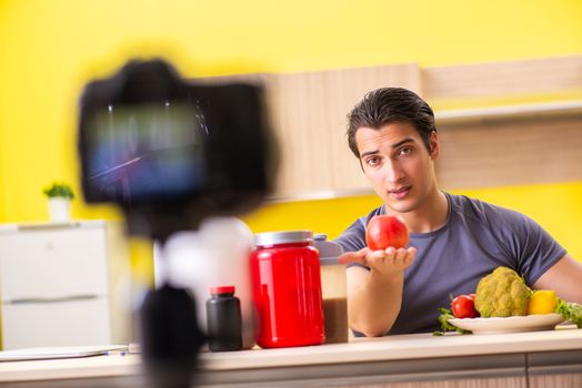 Young man blogging about food supplements