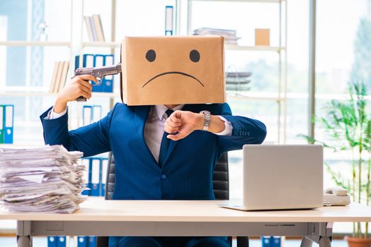 Unhappy man with box instead of his head 