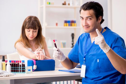 Young patient during blood test sampling procedure  