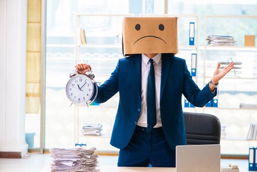 Unhappy man with box instead of his head 