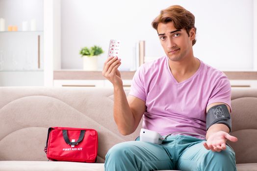 Sick man at home with first aid kit
