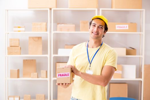 Handsome contractor working in box delivery relocation service 