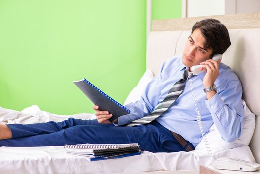 Businessman working overtime in hotel room