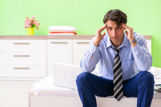 Businessman working overtime in hotel room