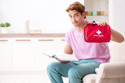 Sick man at home with first aid kit