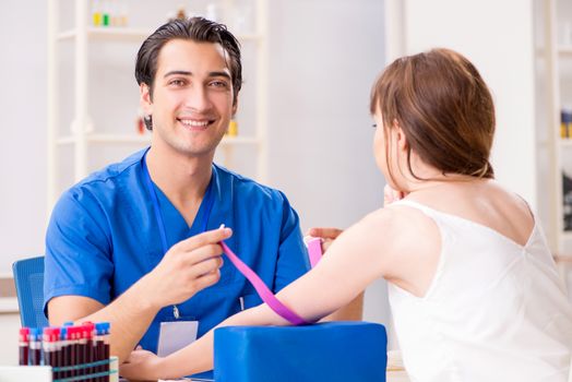 Young patient during blood test sampling procedure  