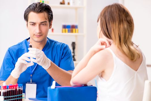 Young patient during blood test sampling procedure  