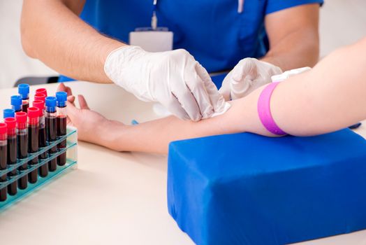 Young patient during blood test sampling procedure  