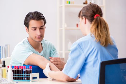 Young patient during blood test sampling procedure  