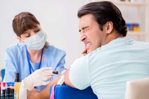 Young patient during blood test sampling procedure  