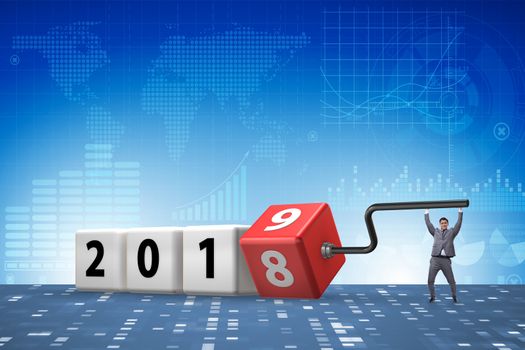 Businessman employee rotating cube to reveal number 2019