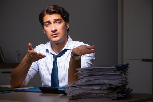 Young financial manager working late at night in office 