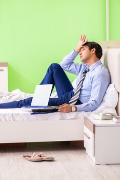 Businessman working overtime in hotel room