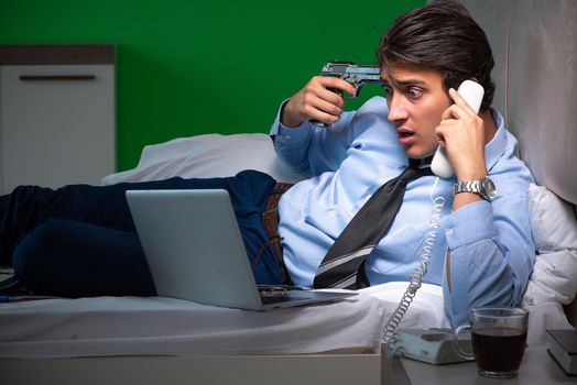 Young businessman under stress in the bedroom at night 