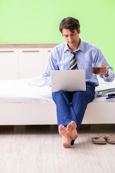 Businessman working overtime in hotel room