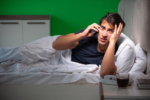 Young handsome man suffering from insomnia at home