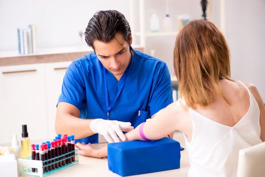 Young patient during blood test sampling procedure  