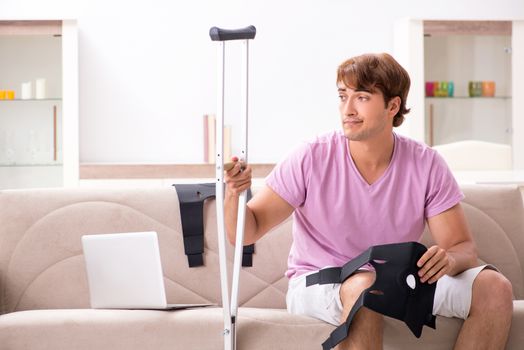 Injured man recovering at home from sports injury