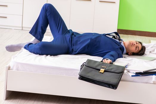 Businessman working overtime in hotel room