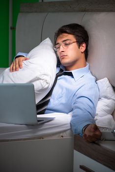 Young businessman under stress in the bedroom at night 