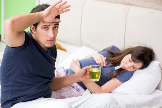 Young husband looking after his pregnant wife