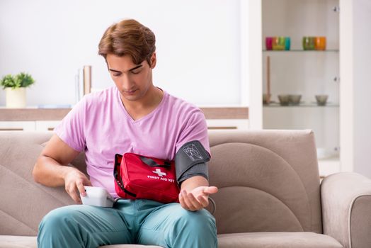 Sick man at home with first aid kit