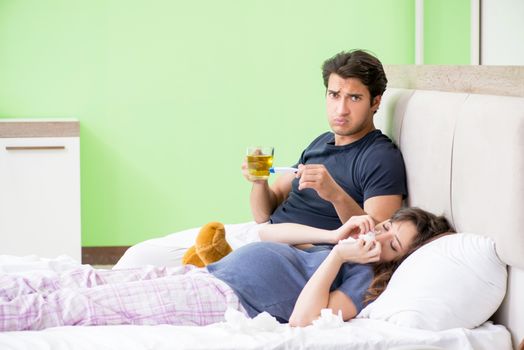 Young husband looking after his pregnant wife