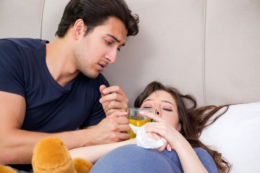 Young husband looking after his pregnant wife