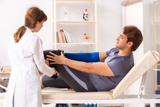 Young male patient visiting female doctor traumatologist 
