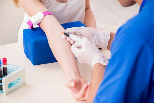 Young patient during blood test sampling procedure  