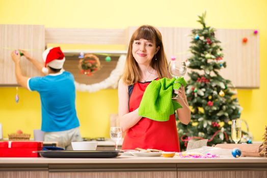 Young couple celebrating Christmas in kitchen 