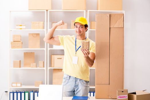 Handsome contractor working in box delivery relocation service 